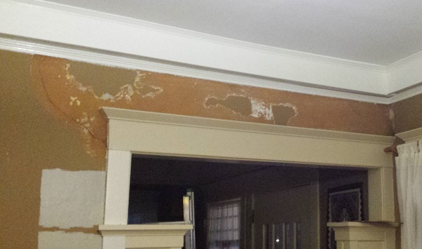 Loose plaster peeled from over doorway