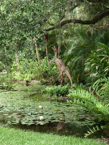 Dinosaur at edge of lily pond