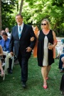 Parents of the groom walking down outdoor wedding aisle