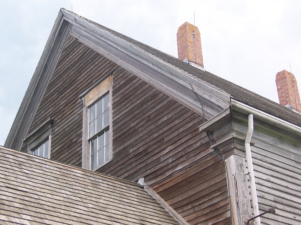 Gable on weathered house, missing window trim