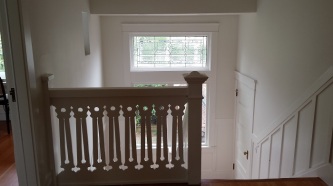 Decorative stairwell railing and leaded glass window